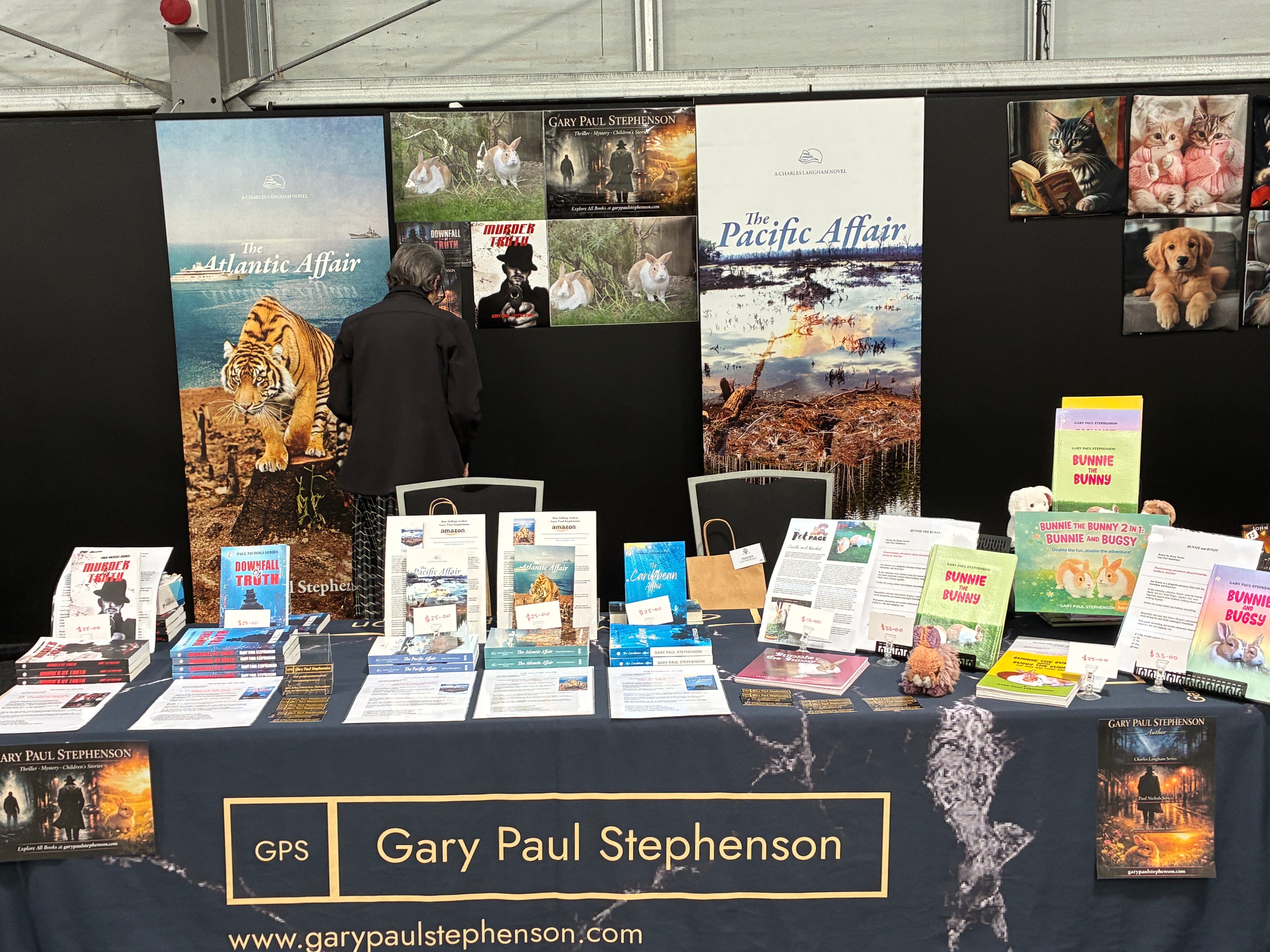 Gary Paul Stephenson's book display booth at the Ages of Pages Book Festival, Hamilton, featuring The Atlantic Affair, The Pacific Affair, Murder Truth, Downfall of Truth, Bunnie the Bunny, and Bunnie and Bugsy.